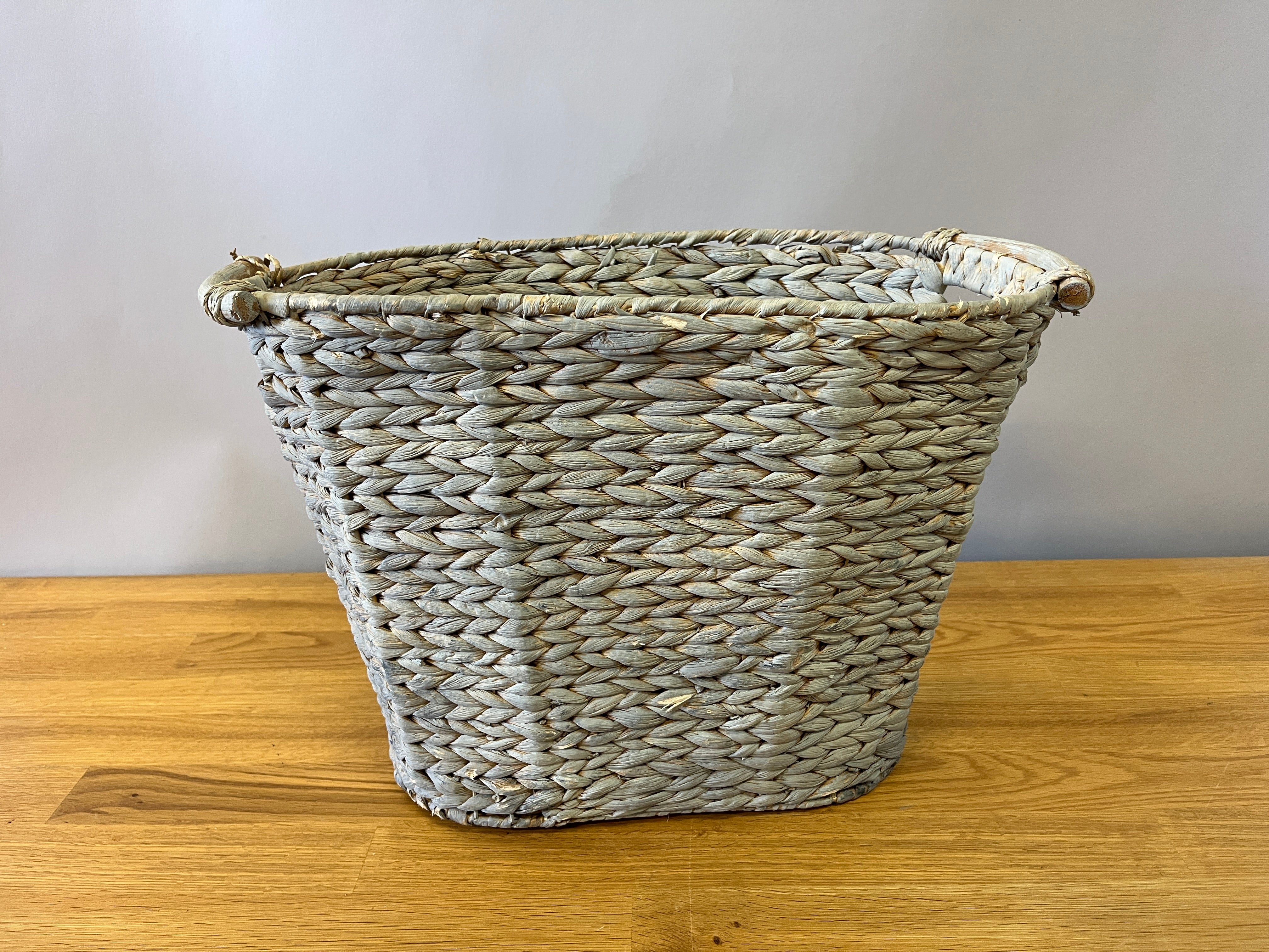 Grey-toned woven basket with handles