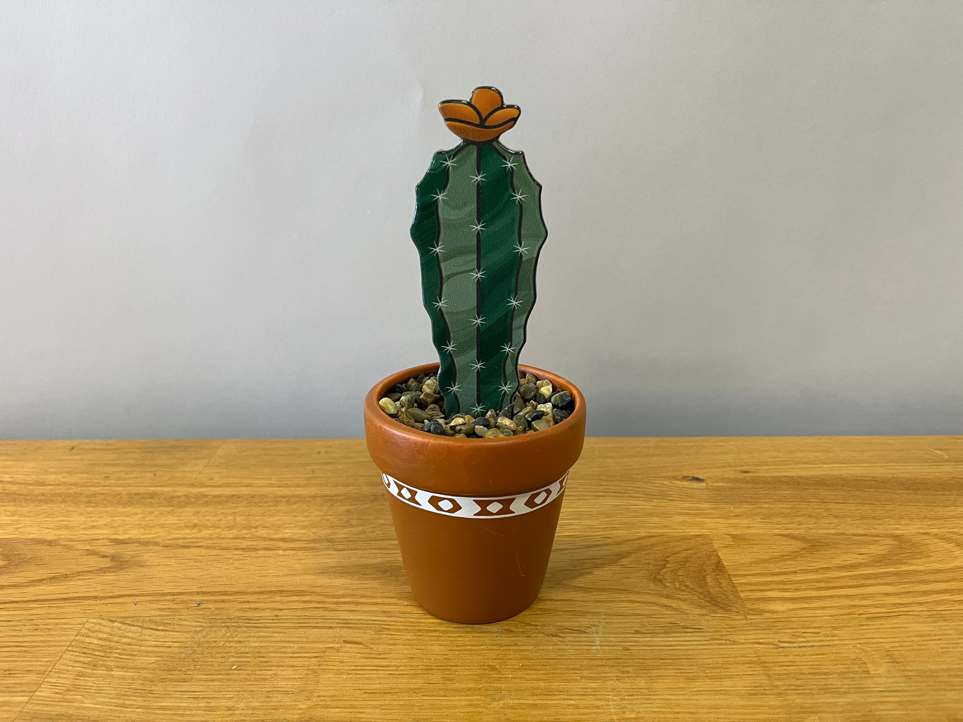 Stained glass cactus in terracotta pot with pebbles
