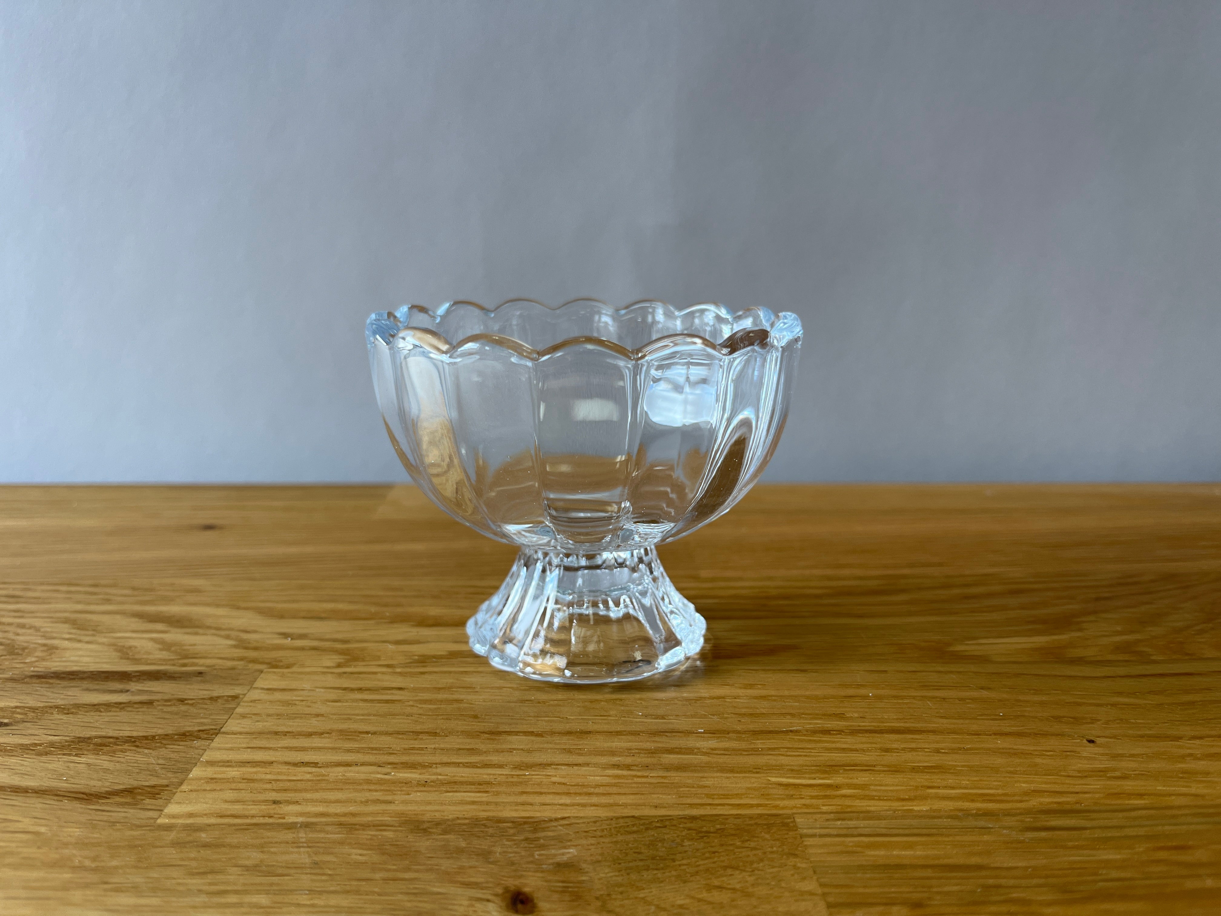 scalloped glass cup on pedestal