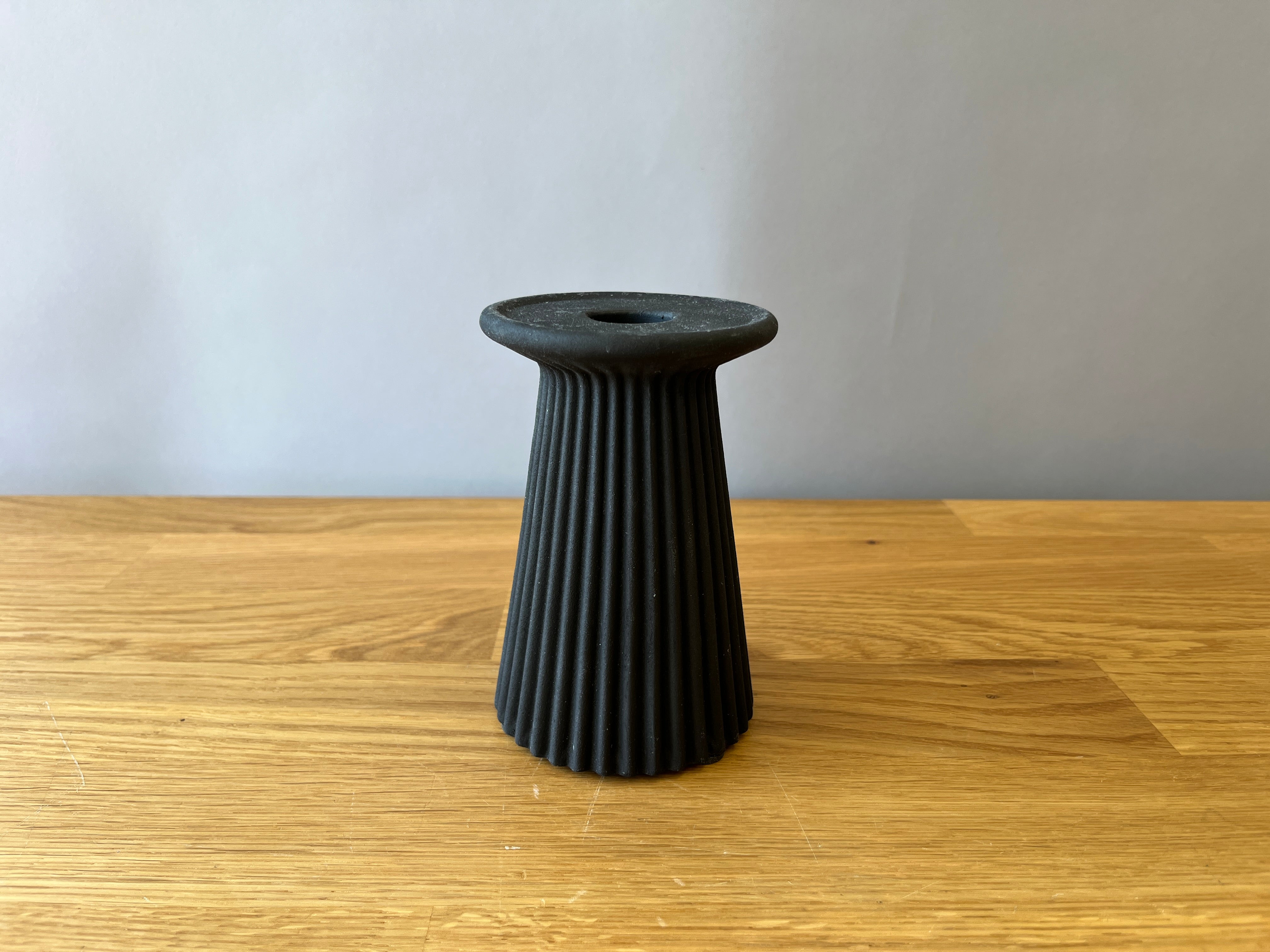 black taper candle holder with ribbed design